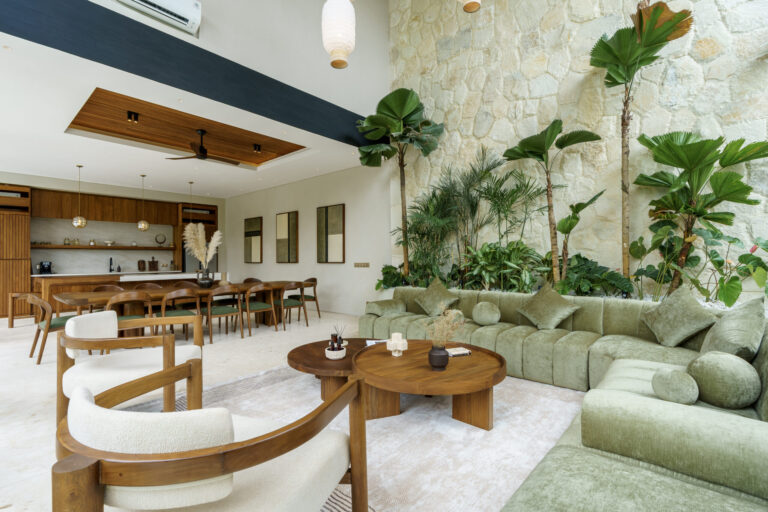 Luxury Bali villa living room with green sofas and dining area