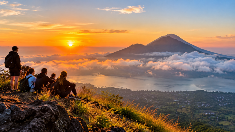 Hikers watching the sunrise over Mount Batur and Lake Batur in Bali
